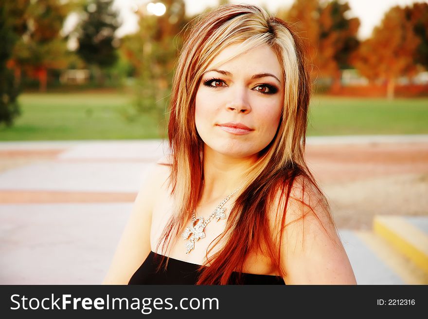 A woman is relaxing in the park. A woman is relaxing in the park