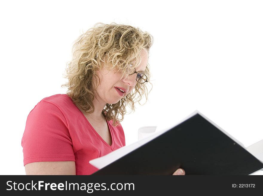 Attractive blonde with glasses checking a folder, isolated on white