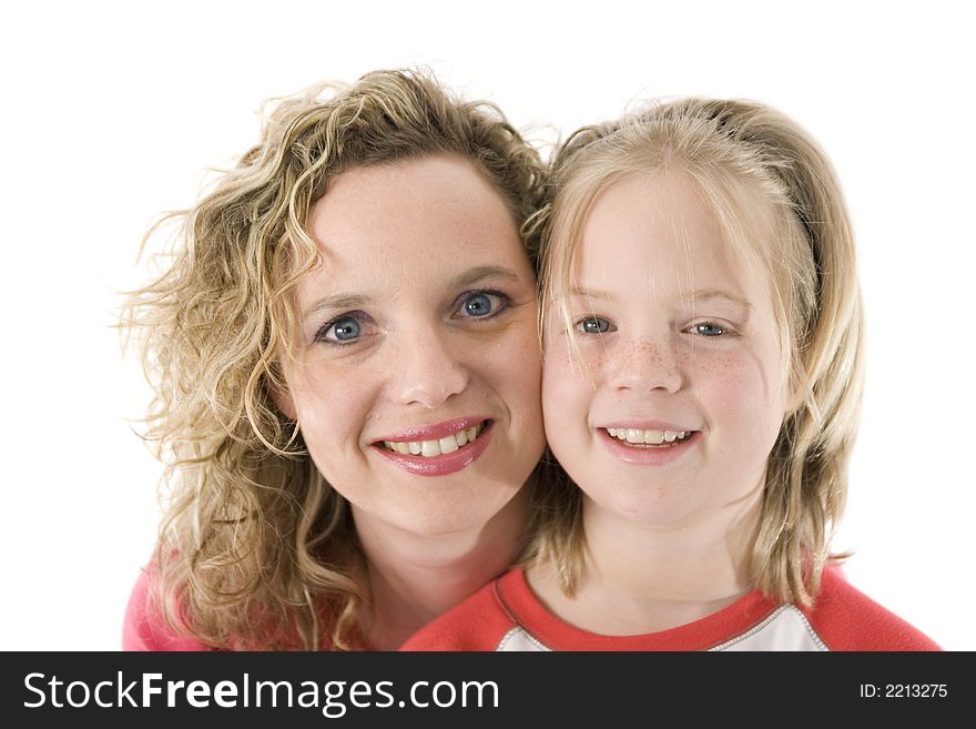 Mother and daughter happily posing in front of the camera, isolated on white