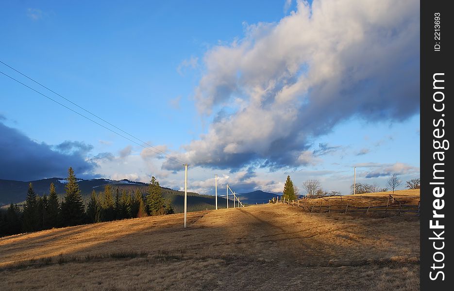 Perspective view on road in mountains. Beautiful clouds.