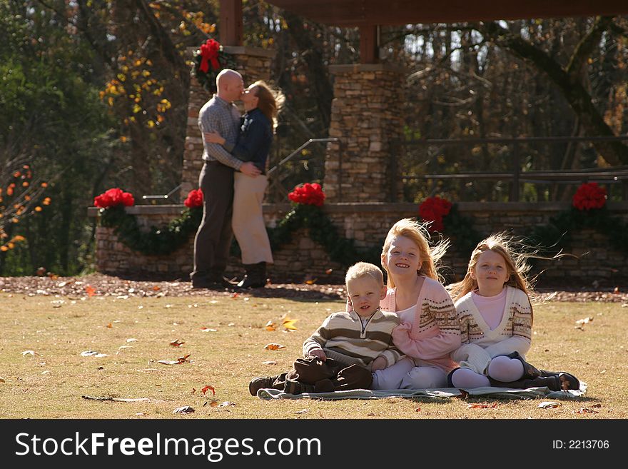 Family posing in on grass for a family portrait