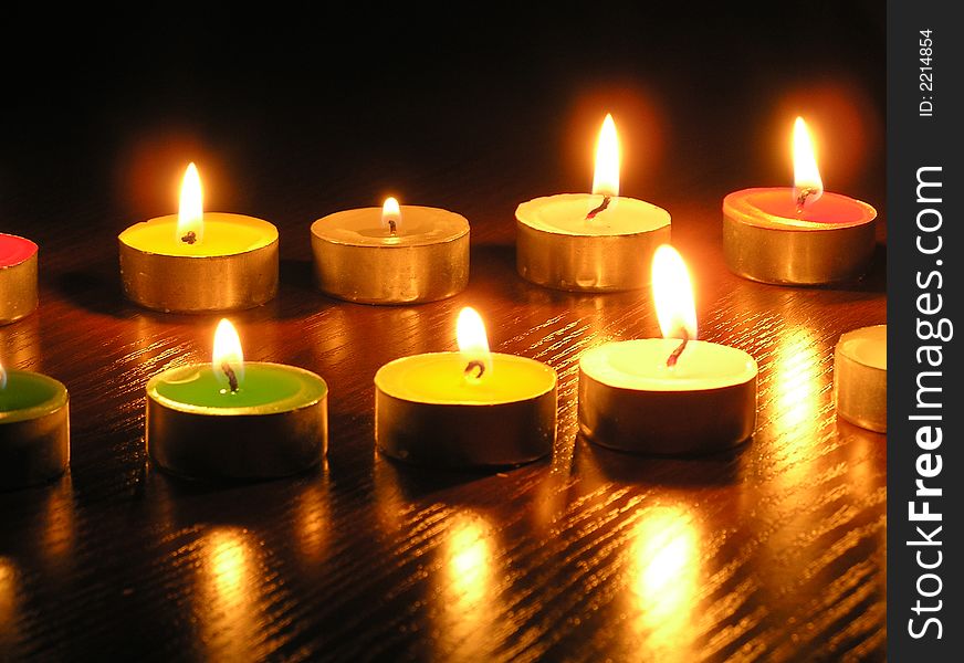 On a photo of a candle as different figures. A photo on a dark background. The photo is made in Ukraine. On a photo of a candle as different figures. A photo on a dark background. The photo is made in Ukraine.