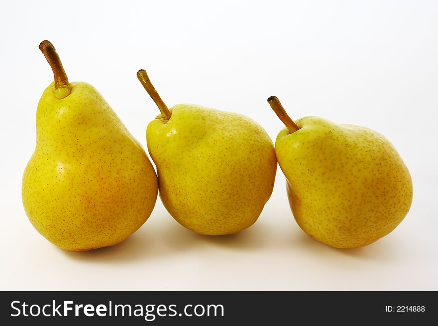 Three yellow pears on white background