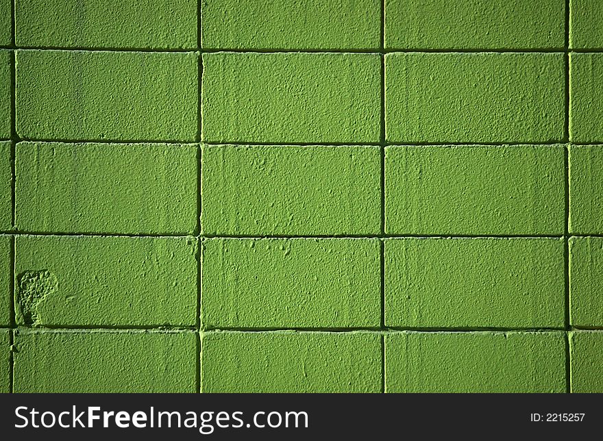 A brick wall with green paint. A brick wall with green paint