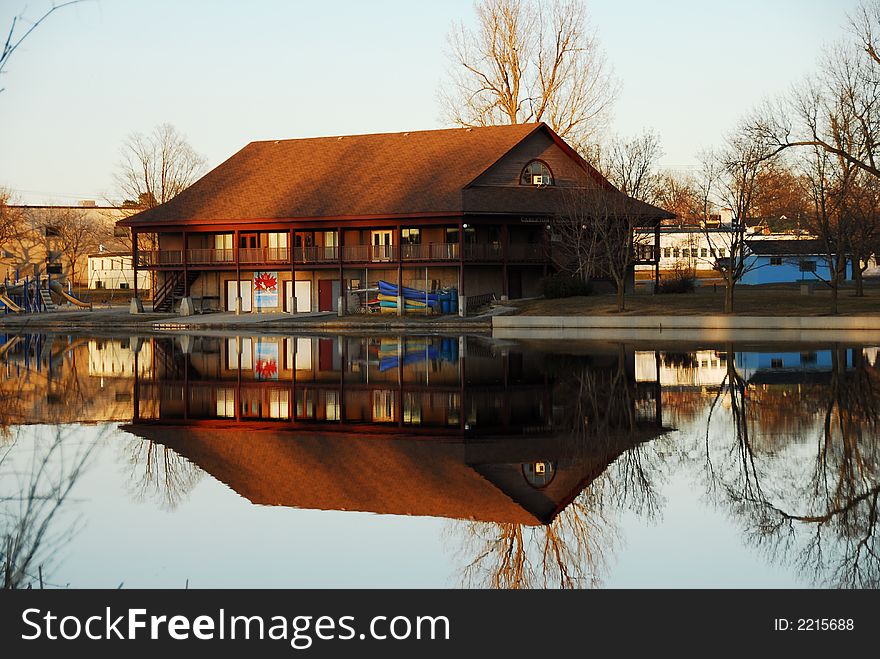 Riverside reflection of canoe club on a spring day. Riverside reflection of canoe club on a spring day