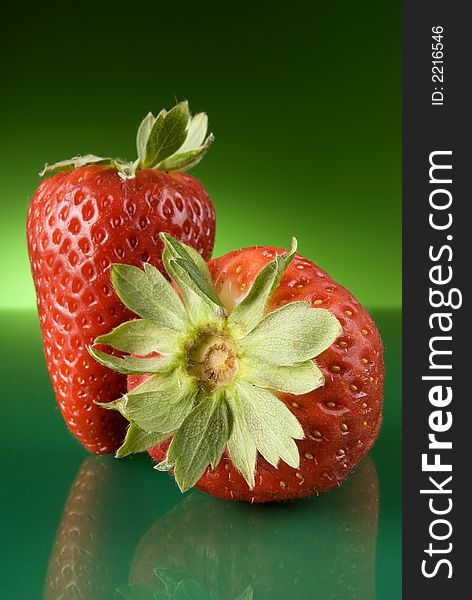 Fresh red strawberries on green background