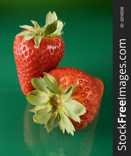 Fresh red strawberries on green background