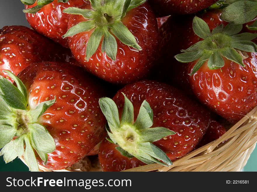 Fresh red strawberries on green background