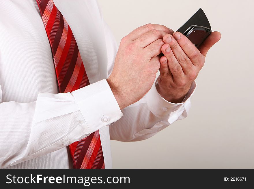 A man in shirt and tie writing on a pda. A man in shirt and tie writing on a pda