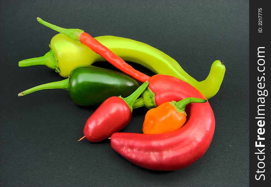 An arrangement of jalapeño, banana, chili, and habanero peppers. An arrangement of jalapeño, banana, chili, and habanero peppers.