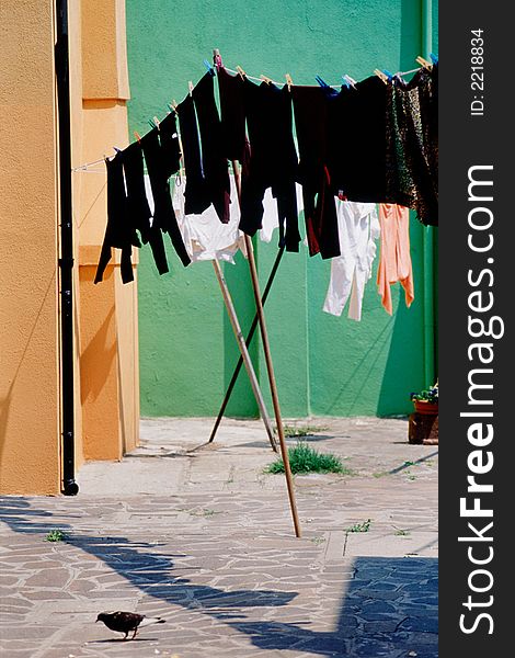 Laundry hanging outdoors on clothesline in Burano, Italy. Laundry hanging outdoors on clothesline in Burano, Italy