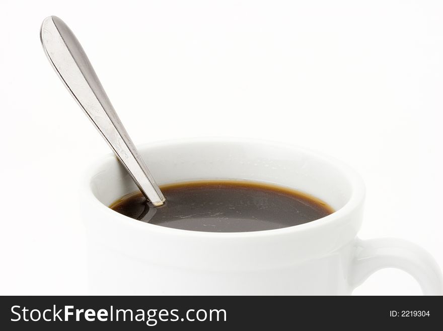 Cup of black coffee with spoon
