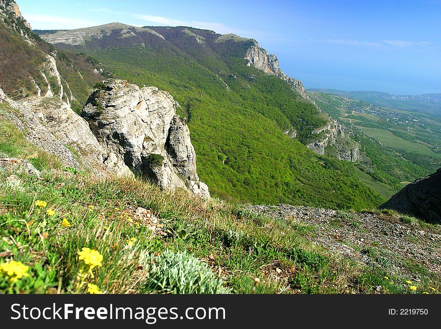 Summer in mountains. The blue sky, transparent air - far are seen villages. On slopes the wood grows. Summer in mountains. The blue sky, transparent air - far are seen villages. On slopes the wood grows