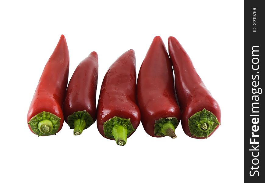 Photo of five chili peppers isolated on white