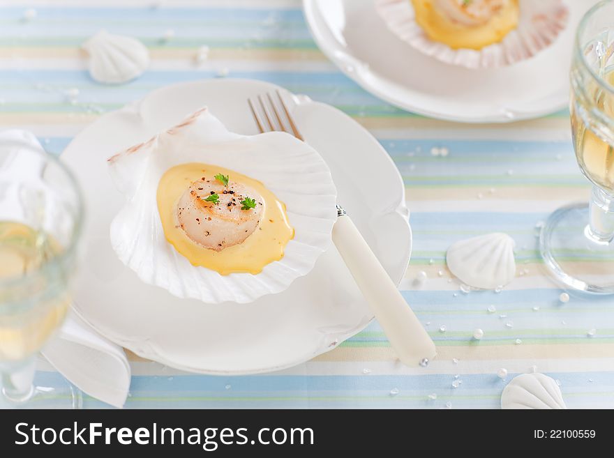 Scallops with saffron sauce on seashell