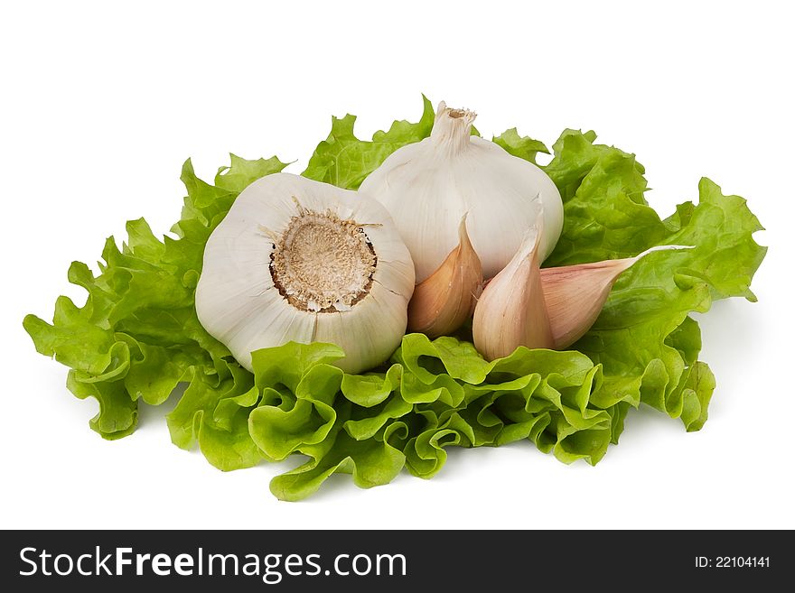 Garlics on lettuce leaves on white