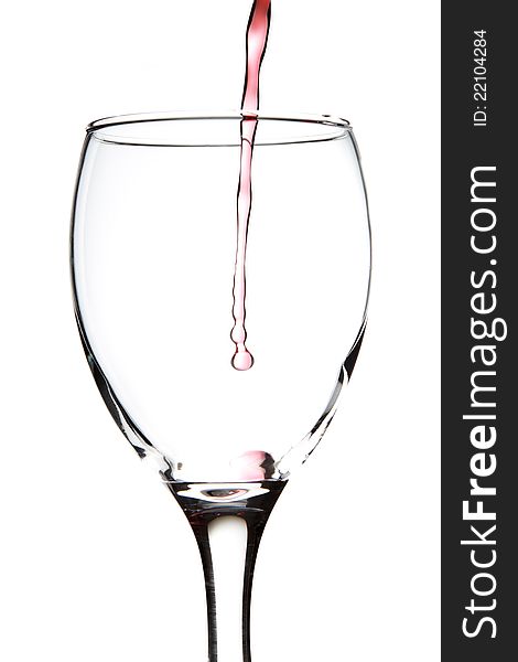 Wine poured into a glass on a white background. Wine poured into a glass on a white background