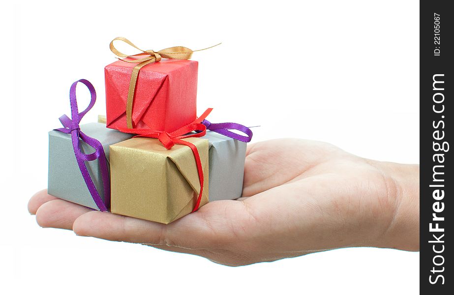 Hands presenting several colourful gift boxes