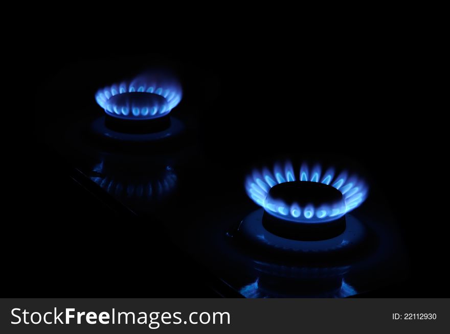 Two gas burners burning with blue flame in the dark. Two gas burners burning with blue flame in the dark