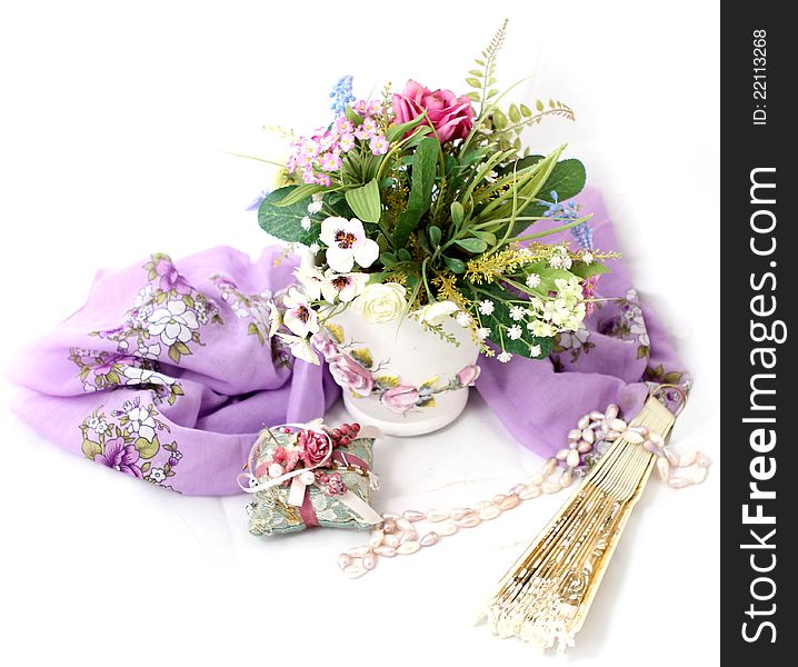 Photo of a still life with flower pot and a fan