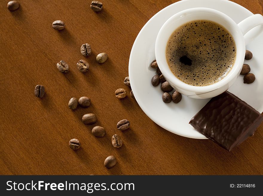 Photograph of a coffee cup and coffee beans. Photograph of a coffee cup and coffee beans