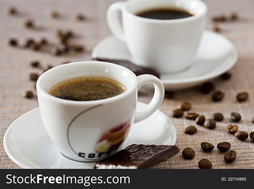 Two coffee cups with chocolate sweets. Two coffee cups with chocolate sweets