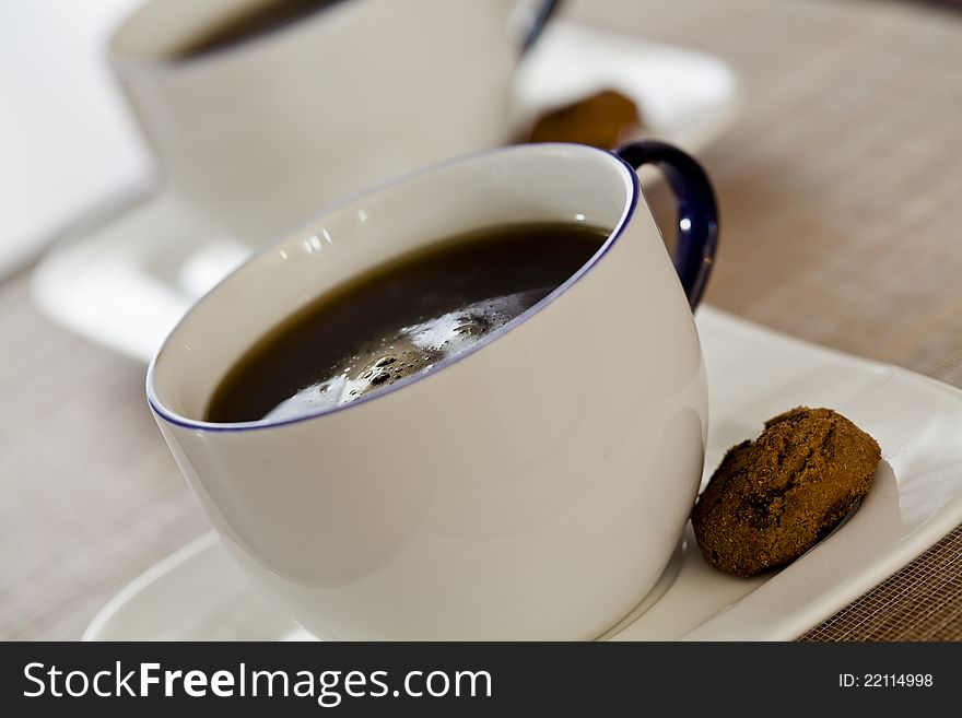 Close up photograph of two coffee cups with cookies. Close up photograph of two coffee cups with cookies