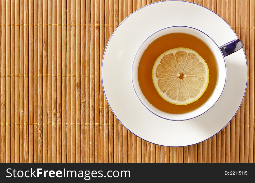 Cup of tea with a slice of lemon viewed from above