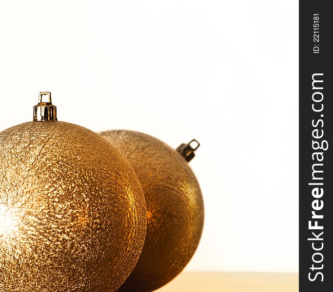 Close-up Photograph of two golden christmas balls