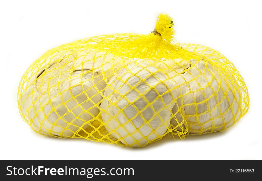 Garlic in yellow bag on white