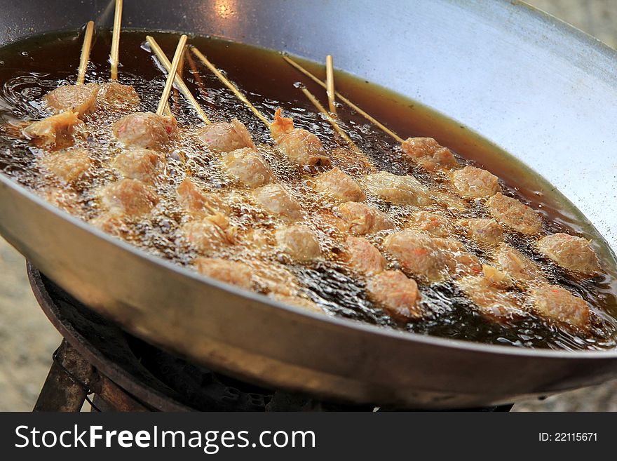 Cooking, Deep frying meatballs in a huge Asian wok