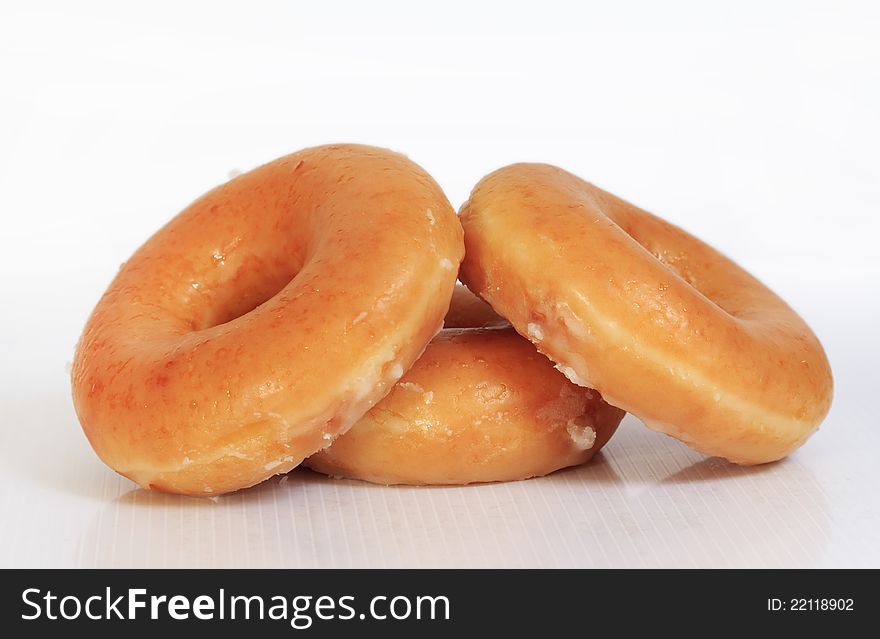 Sweet creamy soft brown donuts on white background