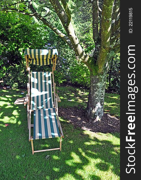 A traditional garden chair in the grounds of a fine english country house. A traditional garden chair in the grounds of a fine english country house