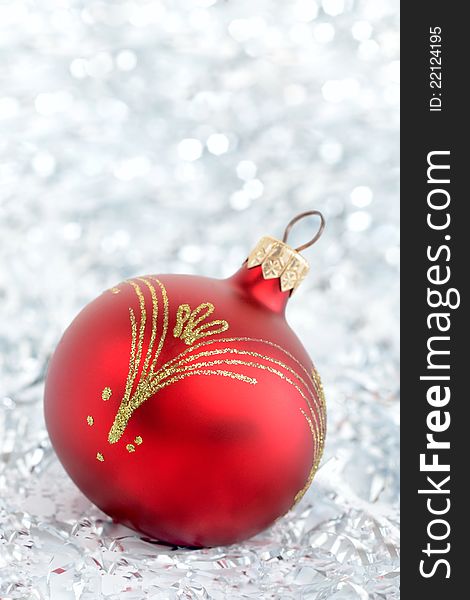 Red Christmas ball with grey lights background