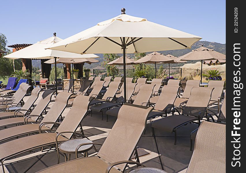 Lounge chairs and parasols outdoors at a luxury resort. Lounge chairs and parasols outdoors at a luxury resort