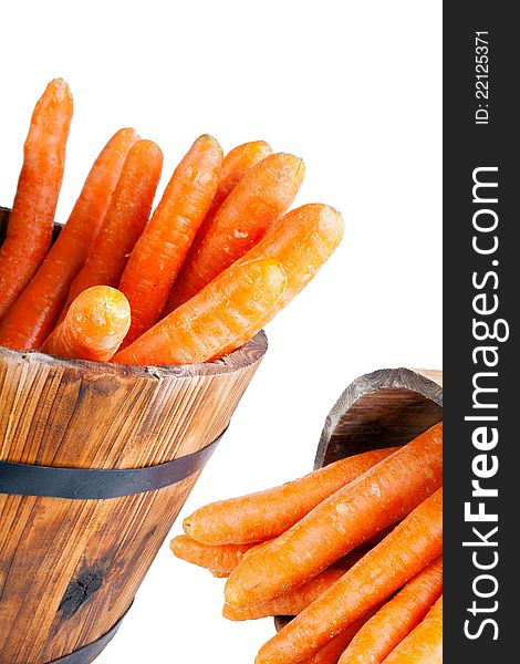 Carrots in wooden barrels, vertical, isolated on white. Carrots in wooden barrels, vertical, isolated on white