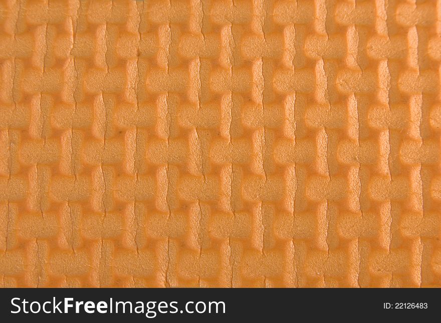 Orange woven rubber texture macro shot. Useful as background for design. Orange woven rubber texture macro shot. Useful as background for design.