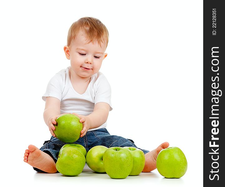 Adorable child with green apples on white