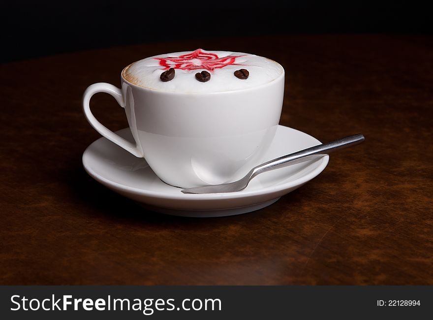 Coffee cup with spoon and cream