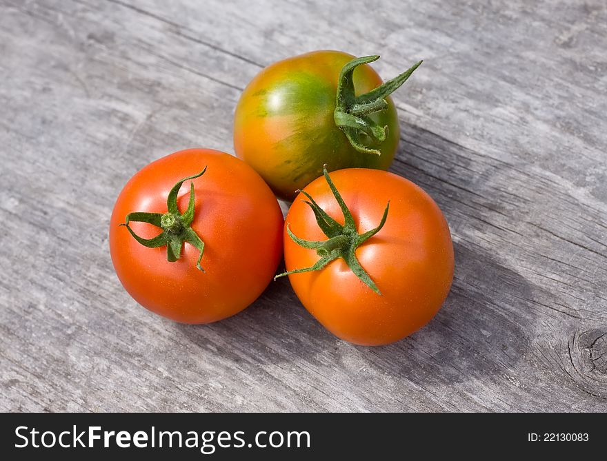 Fresh rural tomatoes on old wooden board