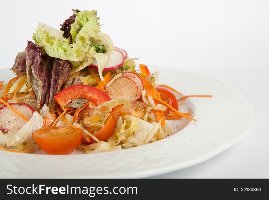 Green vegetables salad on white plate. Green vegetables salad on white plate