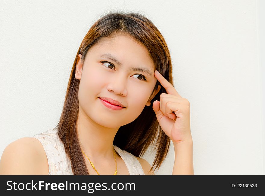 Young cute asian girl thinking on white background