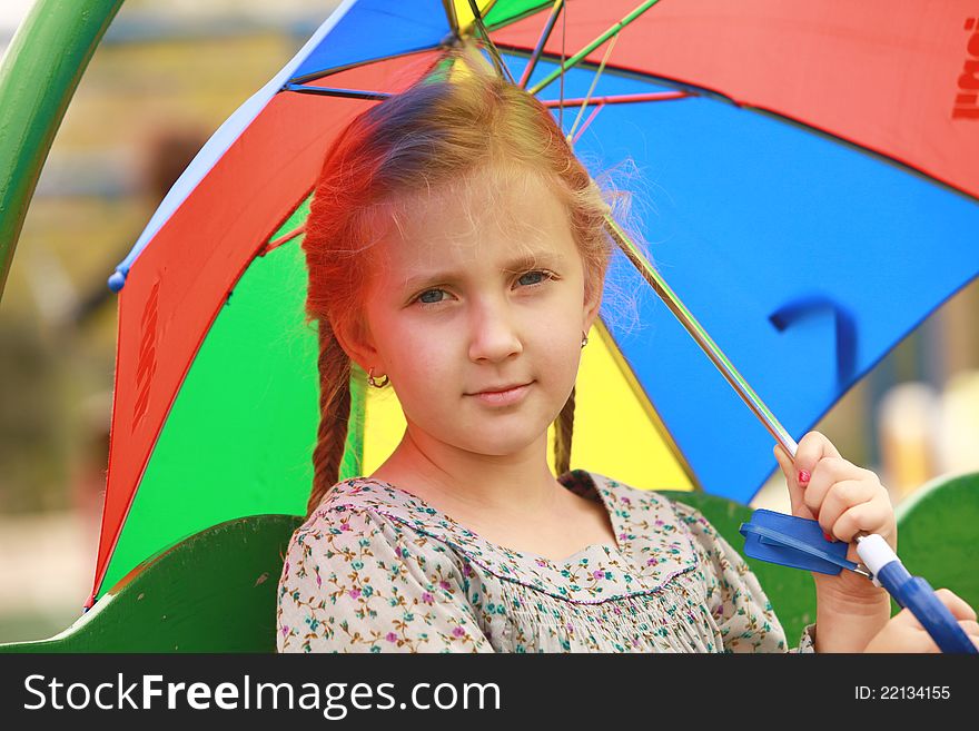 Portrait Of Little Girl With An Umbrella