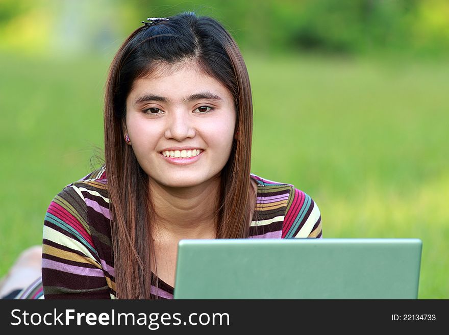 Asian female college student studying with a laptop computer. Asian female college student studying with a laptop computer