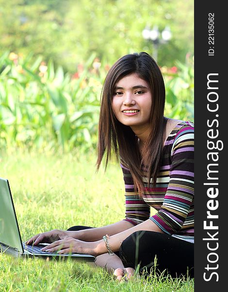 Asian female college student studying with a laptop computer. Asian female college student studying with a laptop computer