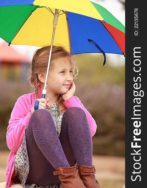 Portrait Of Little Girl With An Color Umbrella