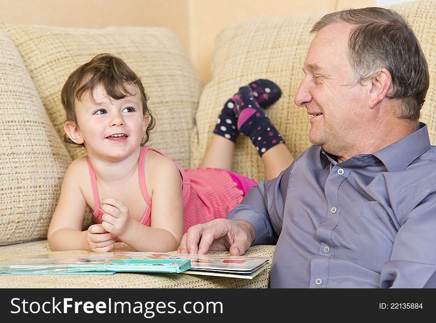 Grandfather reading with grandniece