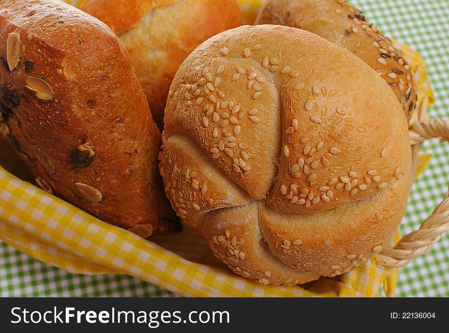 Bread rolls on a cherry wooden plate. Bread rolls on a cherry wooden plate