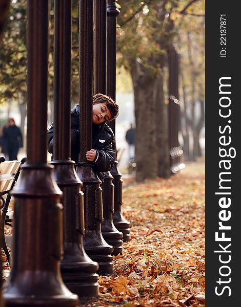 Little Boy In Autumn Park.