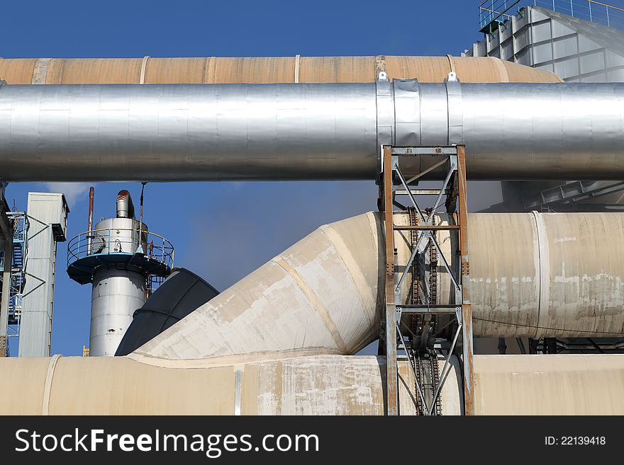 Industrial pipelines against blue sky